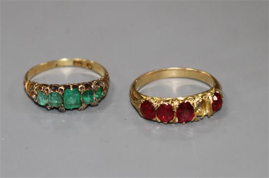 A George V yellow metal, graduated five stone emerald and diamond chip ring and one other four(ex five) stone ring.